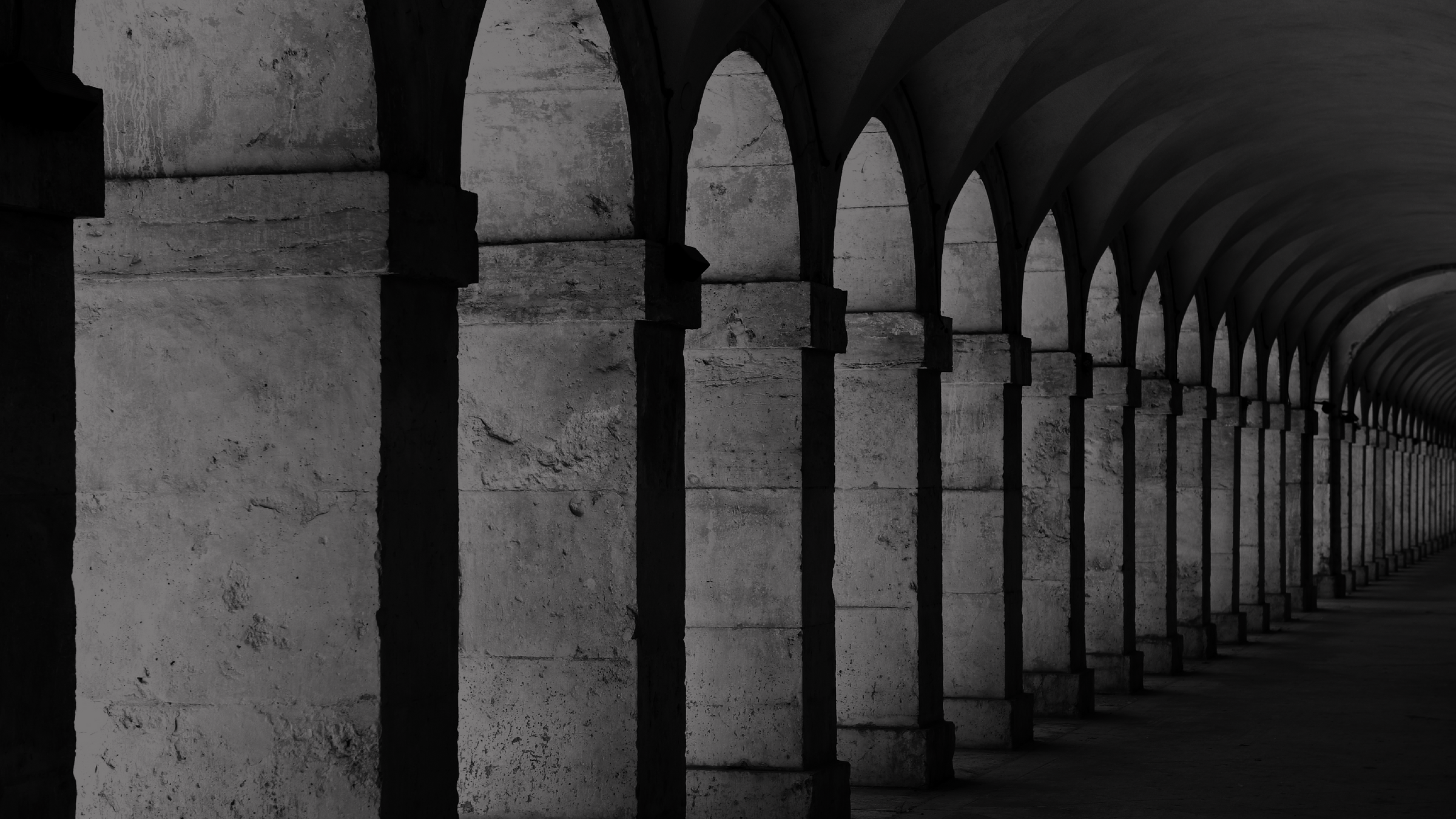 Long row of columns with a dark, moody atmosphere, featuring the brand 'The Classic'.