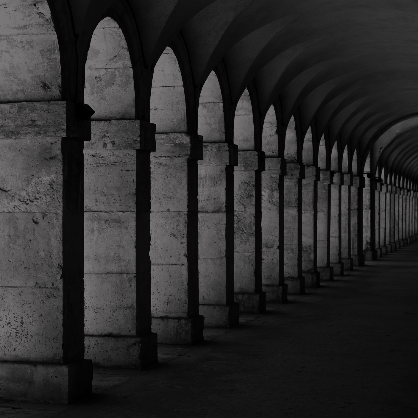 Long row of arches with a dark, moody atmosphere