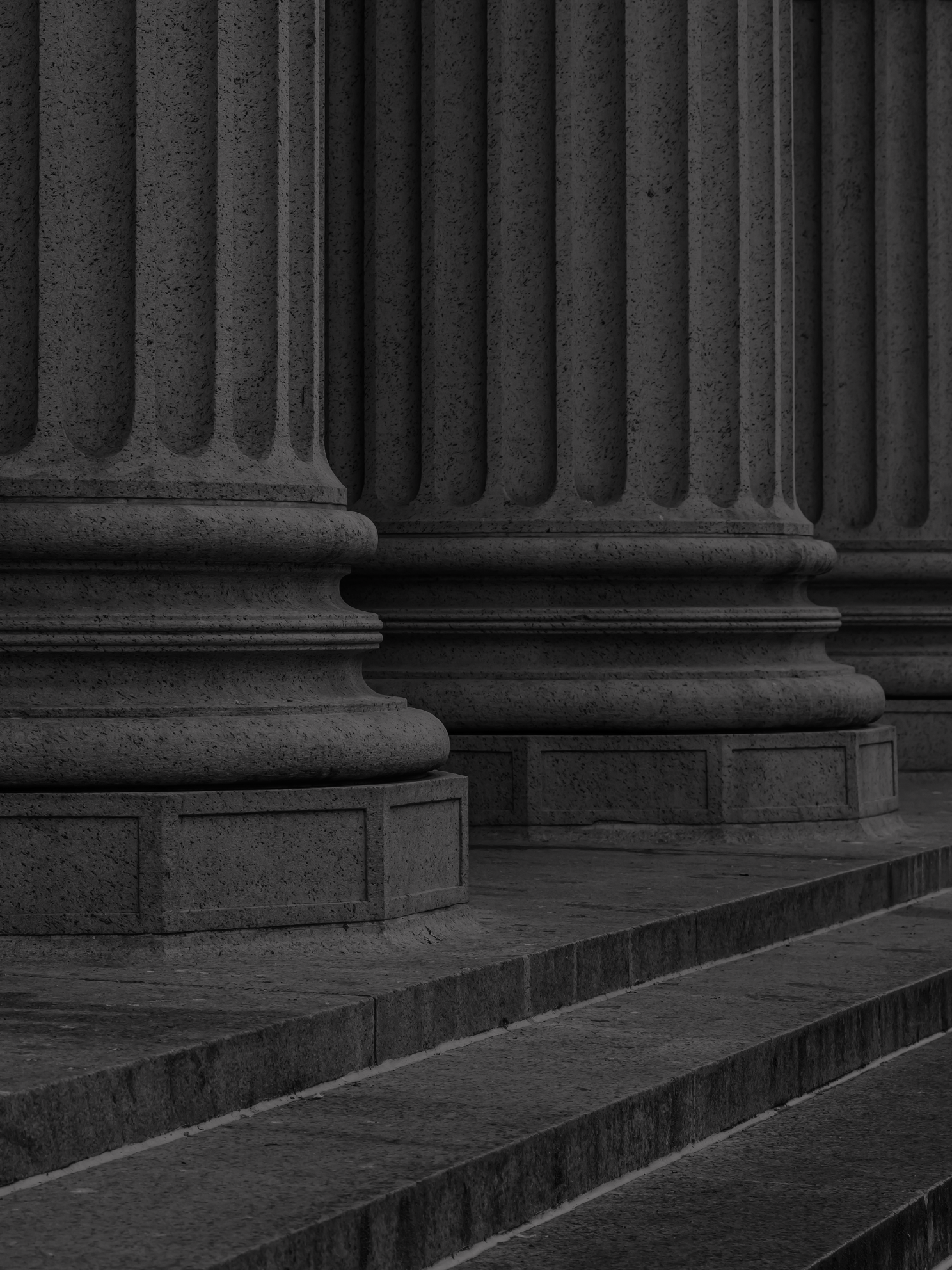 Close-up of classical stone columns with steps in the foreground