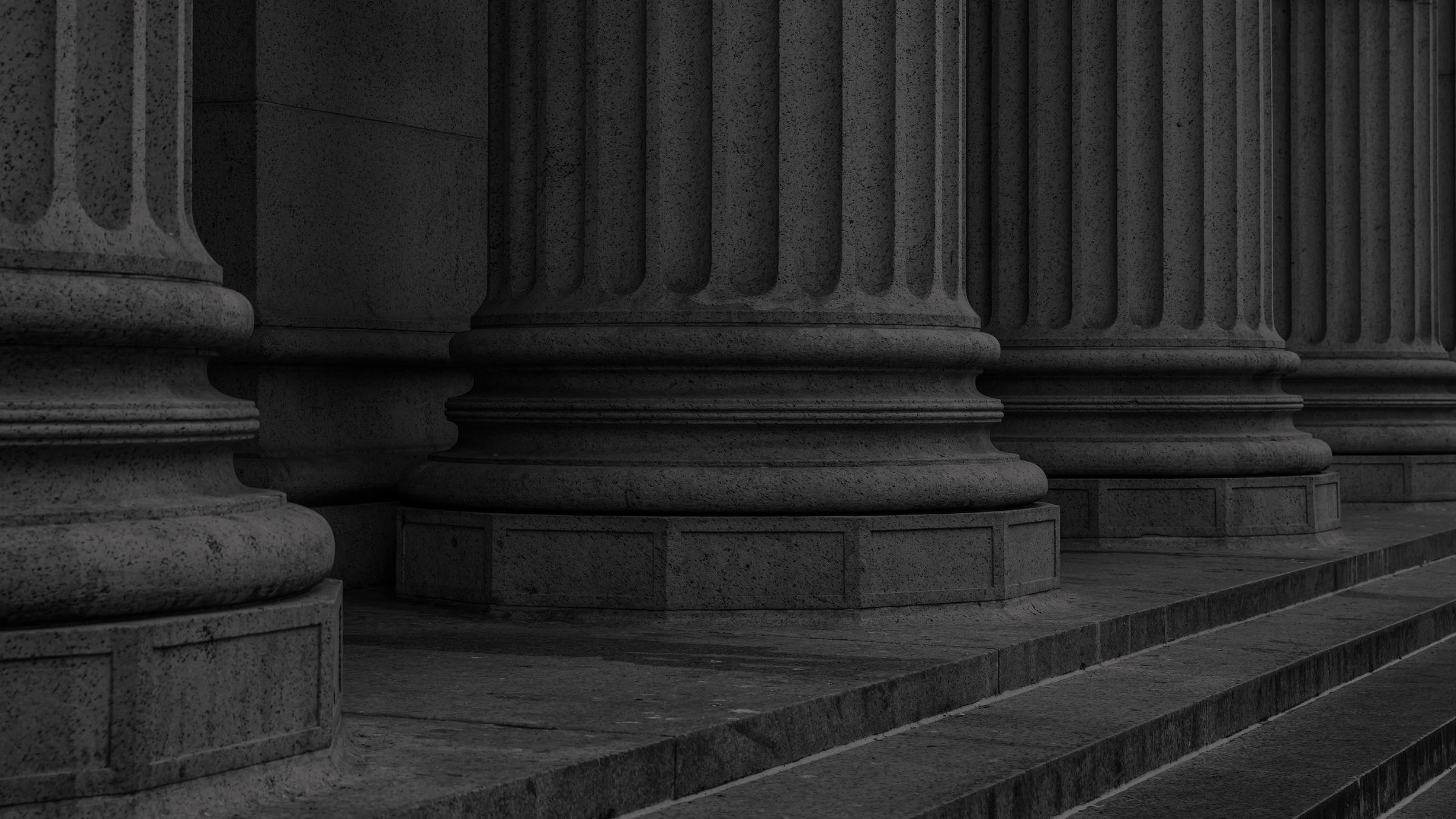 Close-up of classical stone columns with steps in the foreground