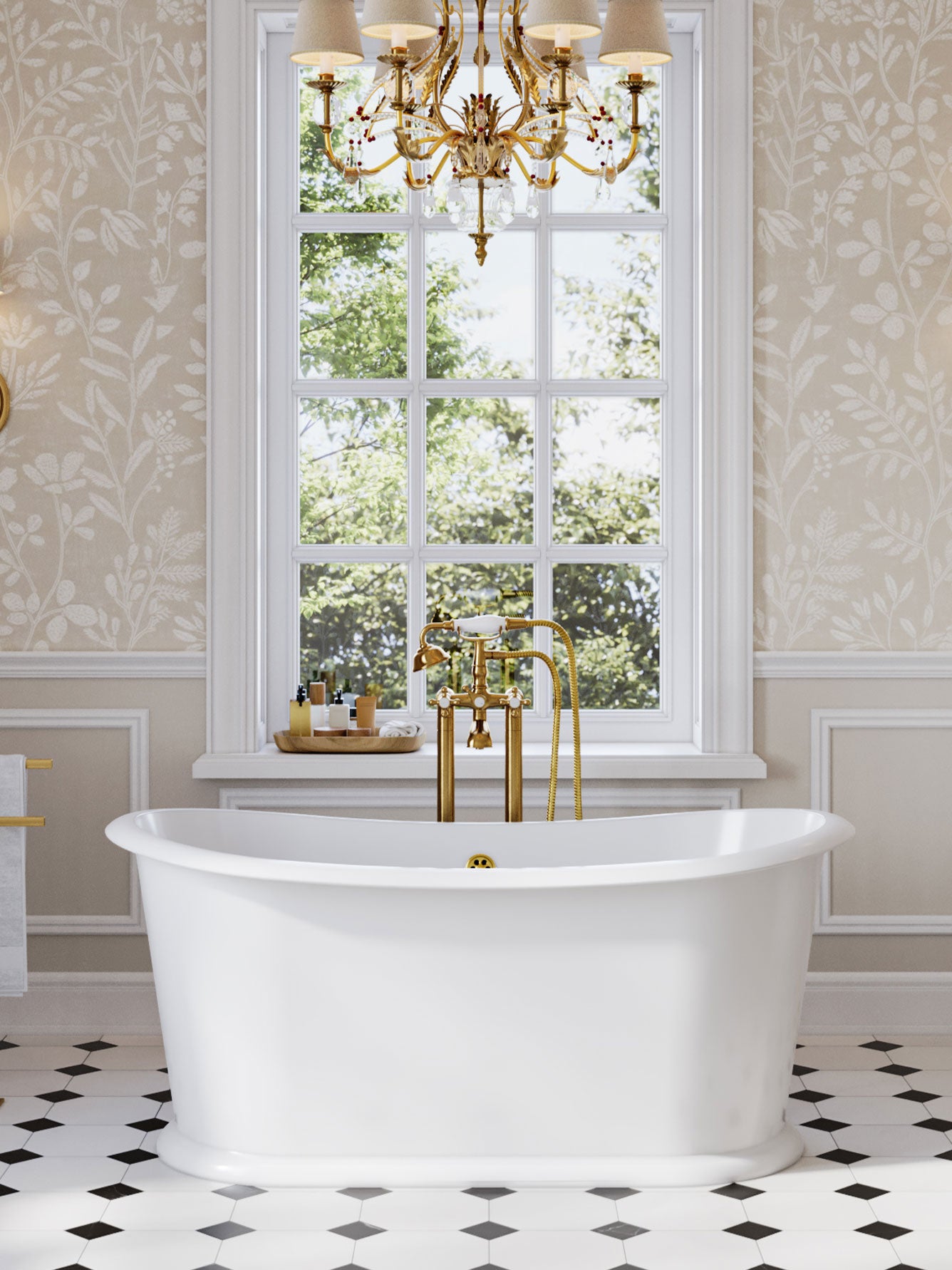 White freestanding bathtub with gold fixtures in a bathroom with floral wallpaper and a large window.