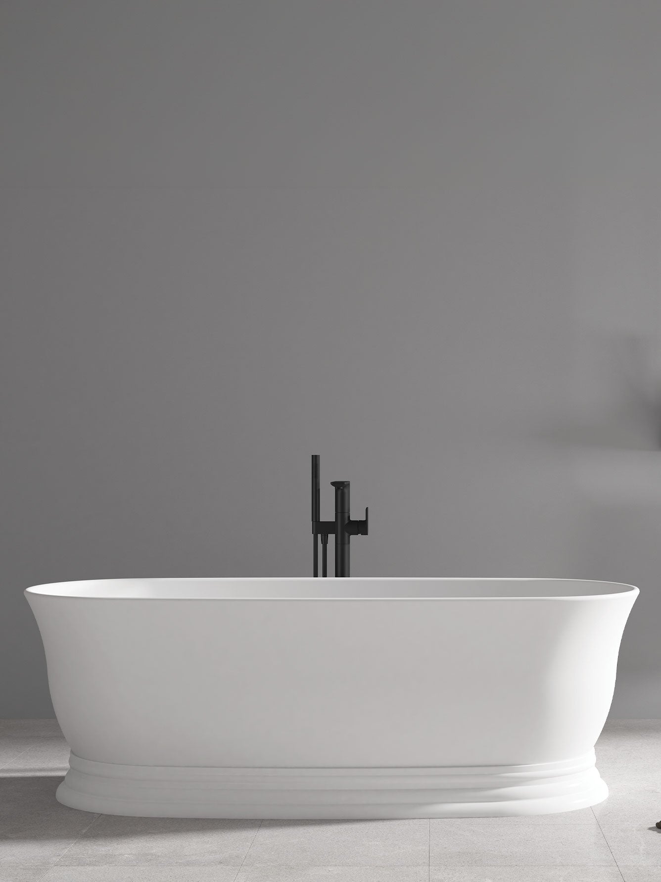 White freestanding bathtub against a gray wall