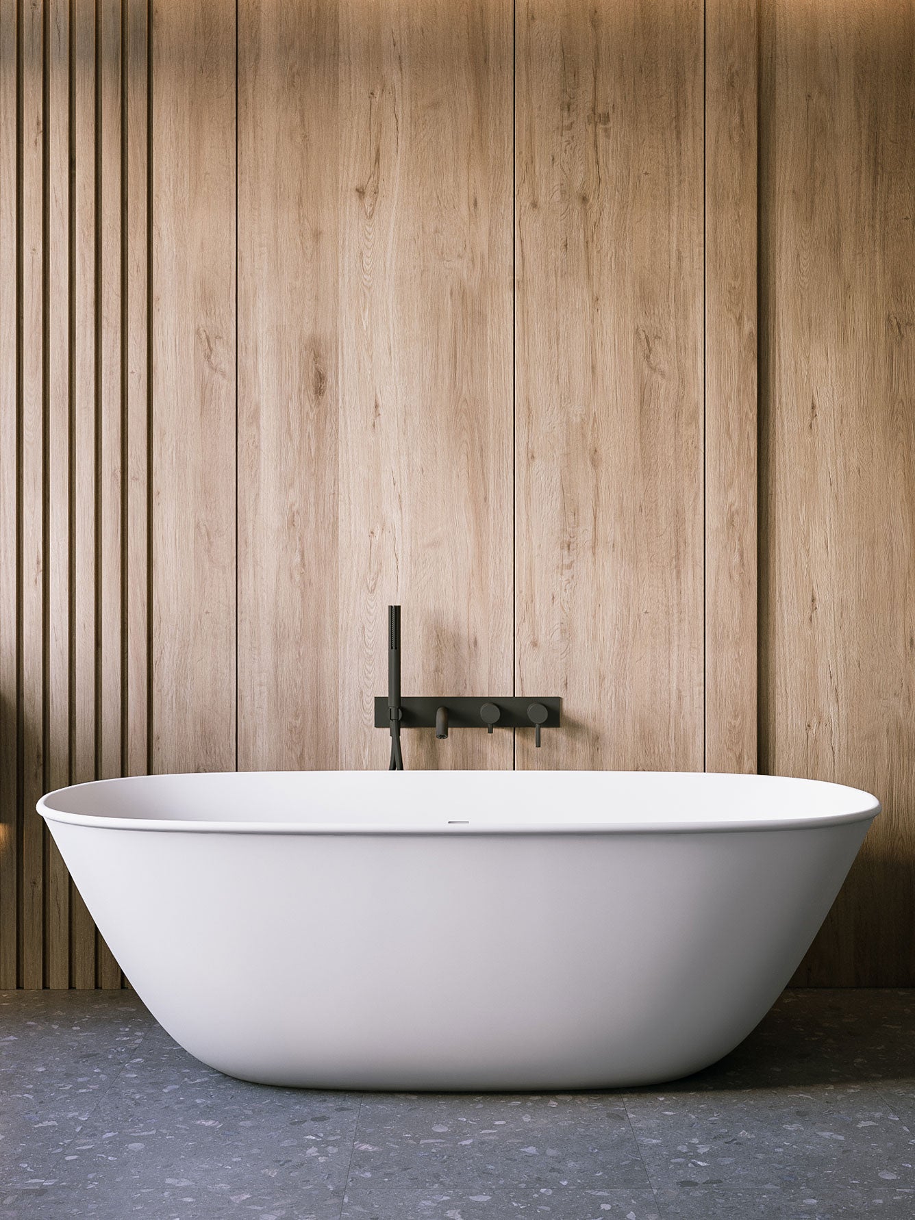 White freestanding bathtub against a wooden wall