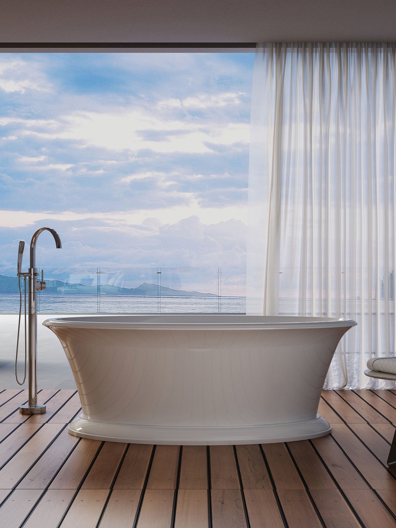Freestanding bathtub on a wooden deck with a scenic view through large windows.