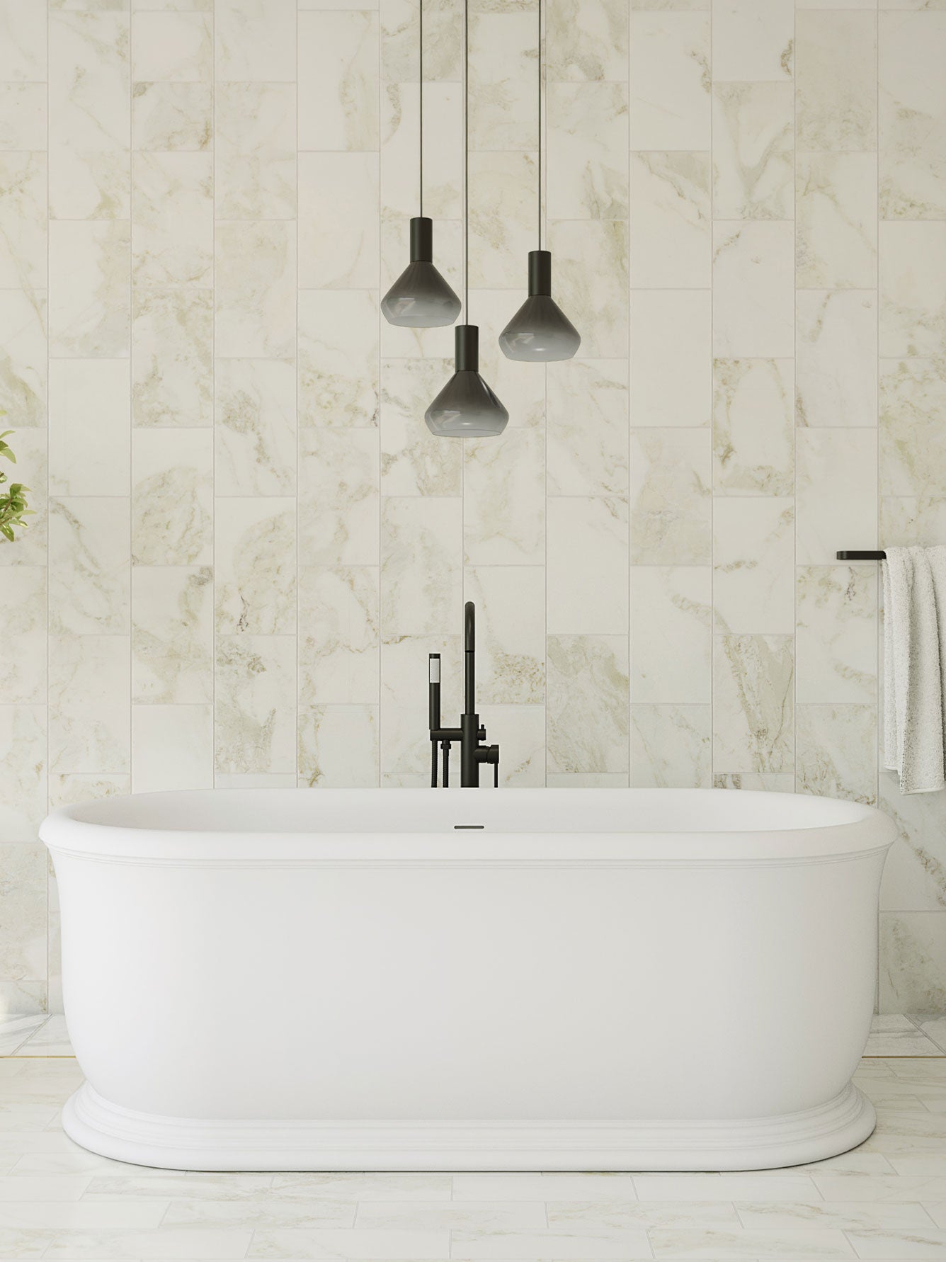 Modern bathroom with a freestanding bathtub, marble walls, and pendant lights.