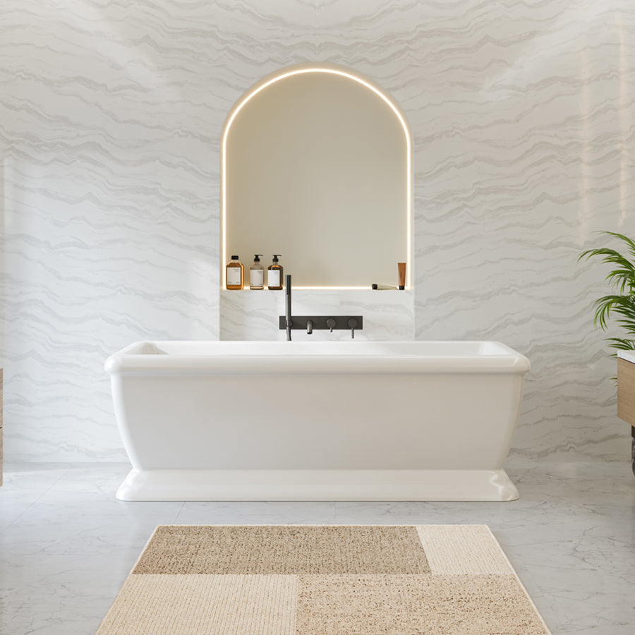 Modern bathroom with freestanding bathtub, mirror, and decorative elements.