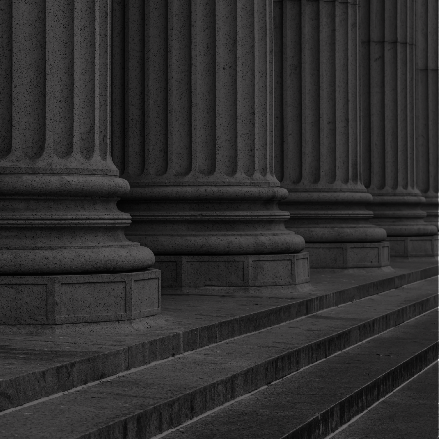 Close-up of classical stone columns with steps leading up to them