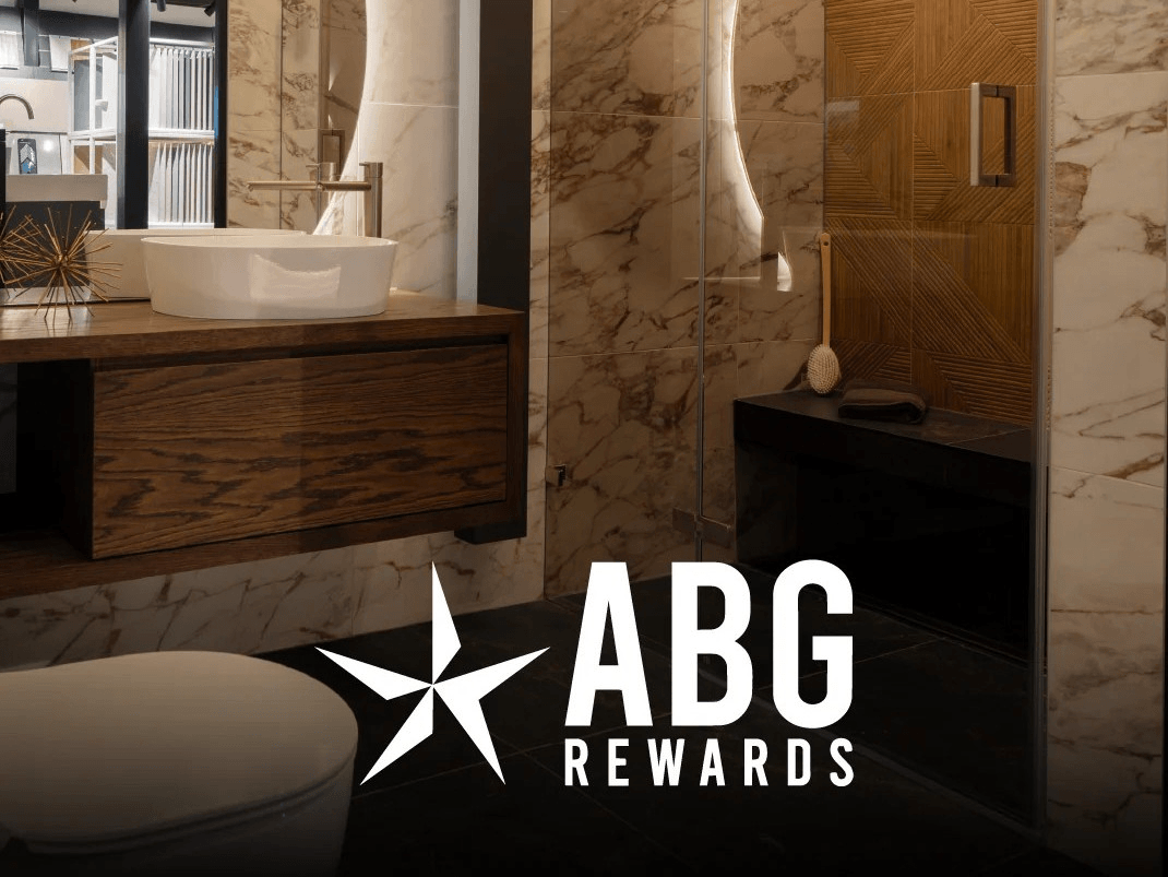 Modern bathroom interior with marble walls and wooden accents, featuring the ABG Rewards logo.