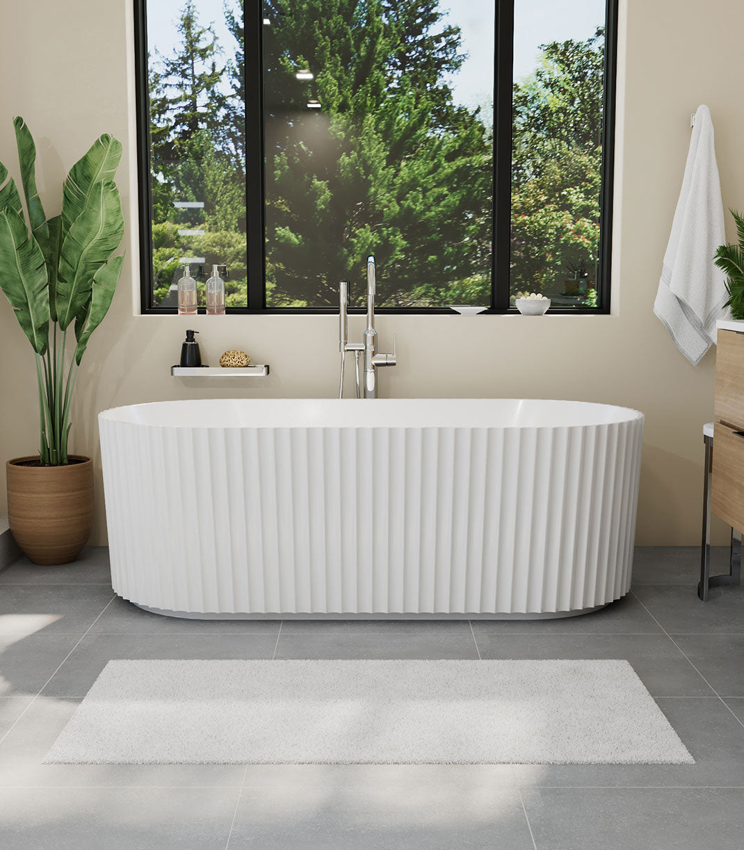 Modern bathroom with a freestanding bathtub, plant, and window view.