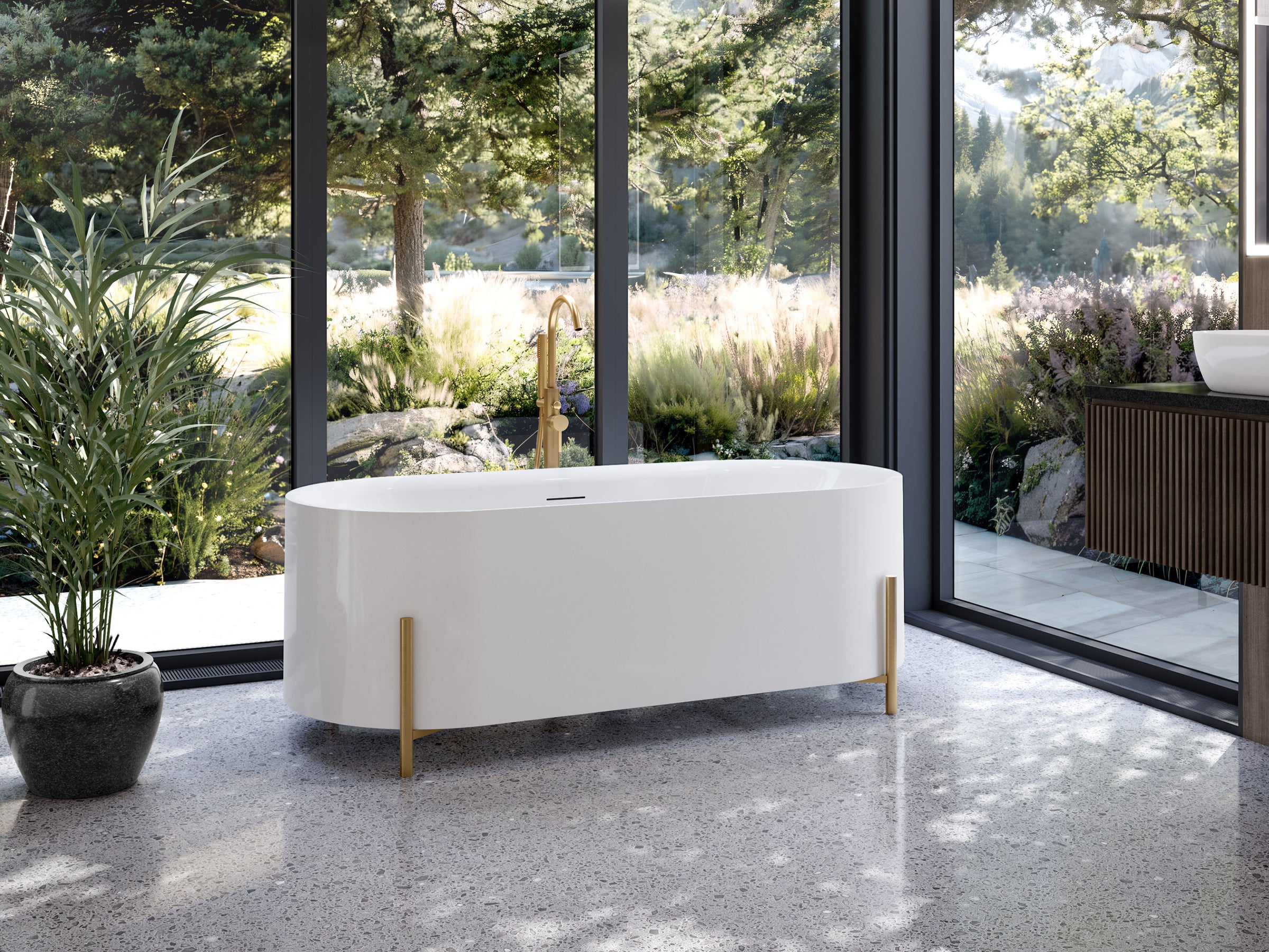 White freestanding bathtub in a modern bathroom with large windows and greenery outside